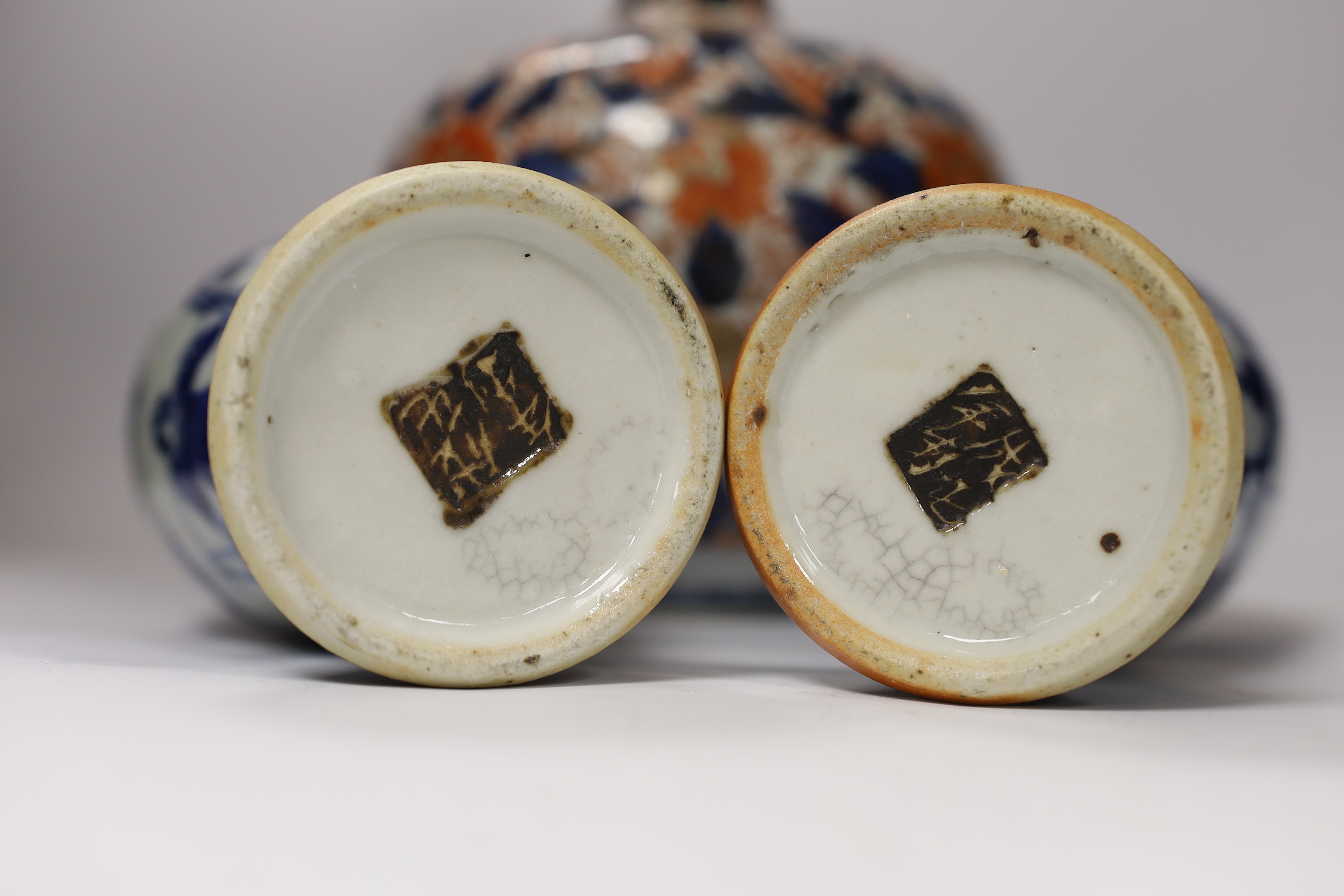 A pair of Chinese blue and white crackleware vases and covers and an Imari vase and cover, largest 31cm high